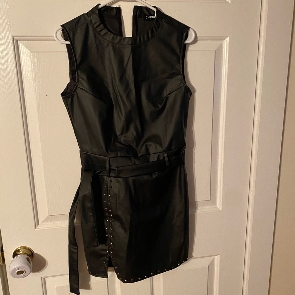 Medium black dress with studded trim line.